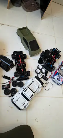 Lot of RC car bodies, chassis and spare wheels - for parts or repair