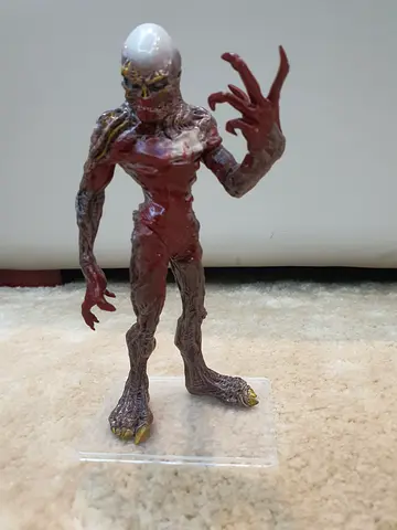 Hand-painted collectible horror figure with translucent head on display stand sighned by the creator