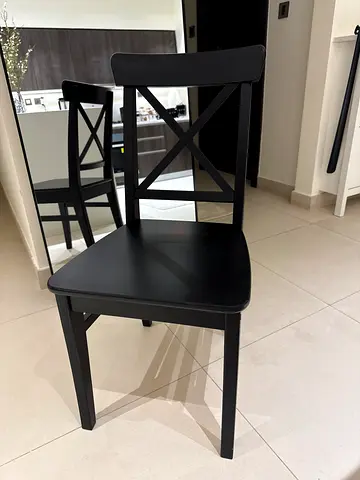 Set of 6 black wooden ikea dining chairs with cross-back design
