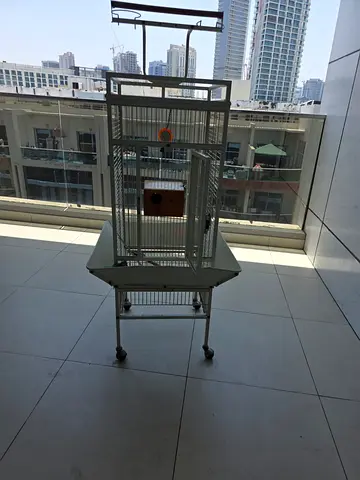 Large metal bird cage on stand with wheels and wooden nest box
