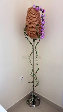 Woven rattan floor lamp with decorative vine