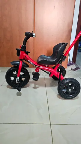 Red toddler tricycle with parent push handle — good condition