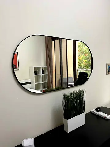 Black-framed wall mirror