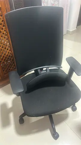Black ergonomic office chair with armrests and wheels - good condition