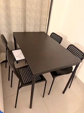 Simple dark wood dining table with 4 matching chairs
