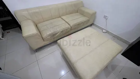 Used cream leather 3-seater sofa with matching ottoman - fair condition