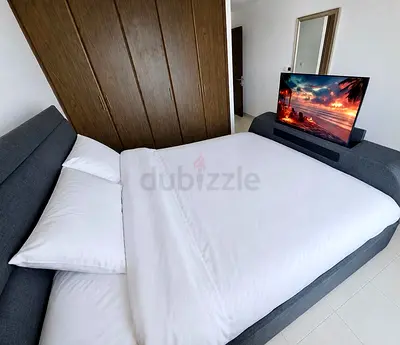 Grey fabric Super-King bed with integrated Blue-tooth speakers and 4K Smart-TV automatic riser