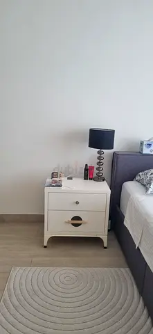 White wooden bedside table with drawer and shelf - good condition