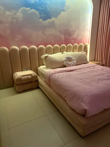 Upholstered blush pink bed with padded headboard (fixed) and matching bedside tables