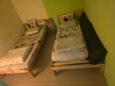 Set of two simple single wooden beds with mattresses - good condition