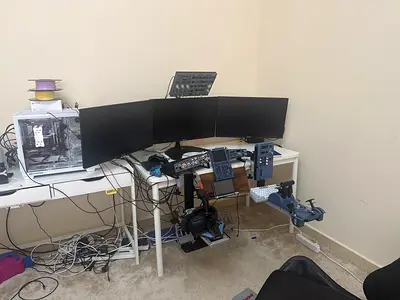 a full flight sim setup with 3 monitors chair desk and a gaming pc