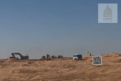 Residential land for sale in Umm Al Quwain with a convenient installment plan including all fees. Ground floor and two-story building permit.