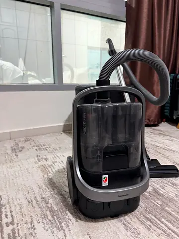 Used canister vacuum cleaner - works well, includes hose and floor head