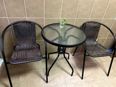 Round Glass Table with Two Rattan Style Chairs