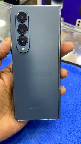 Used sleek grey Android phone with triple rear cameras - good condition
