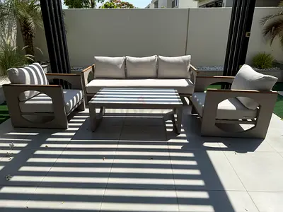 Outdoor 4-piece patio lounge set with coffee table — neutral cushions, good condition, pickup only