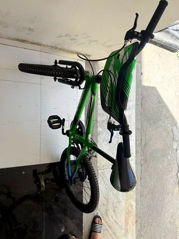 Green kids 20-inch bicycle with training wheels - good condition