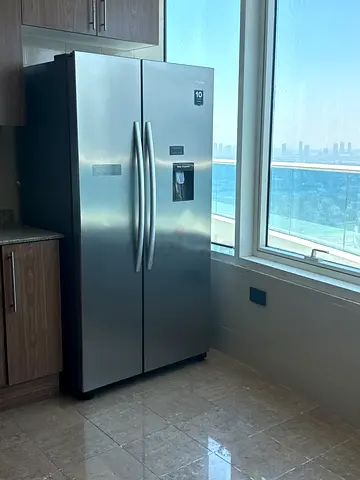 Stainless Steel Side-by-Side Refrigerator with Water Dispenser - Good Condition