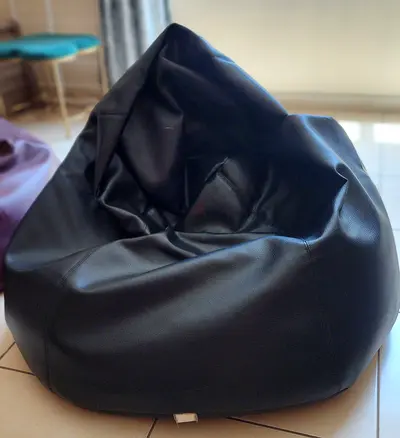 Black faux-leather bean bag chair — gently used