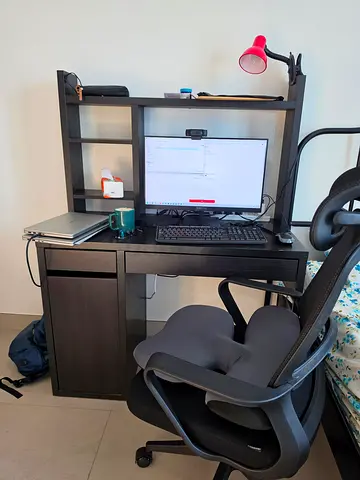 IKEA black computer desk with hutch and rolling office chair