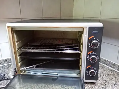 Very rarely used countertop electric oven - works well, includes trays and rotisserie