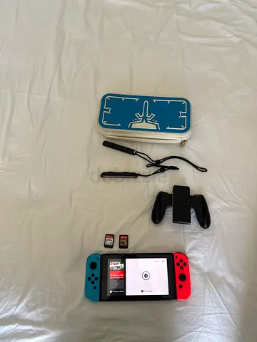 Nintendo Switch console with Joy-Cons, 2 games, case and accessories - good condition