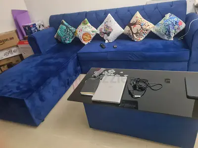 Blue L-Shaped Sectional Sofa with Cushions and Coffee Table