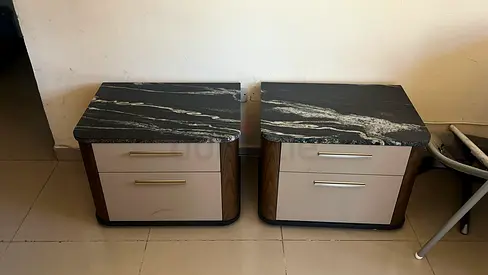Pair of bedside nightstands with marble tops and drawers