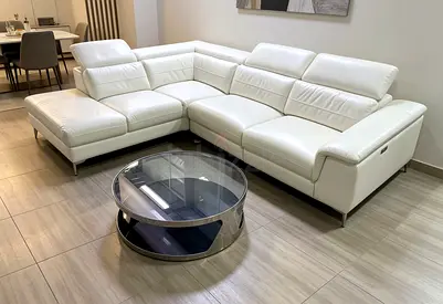 White leather L-shaped sectional sofa with adjustable headrests