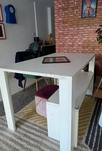 White rectangular dining table with a bench