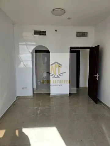 Apartment for sale in Sharjah – Al Khan: two master bedrooms, a living room, and a guest bathroom; area: 1,100 sq. ft.; includes parking; service char