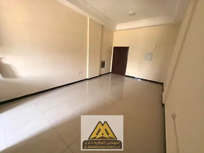 A spacious studio apartment with a semi-separate kitchen in Al Muwaihat 1, close to all services and main roads.