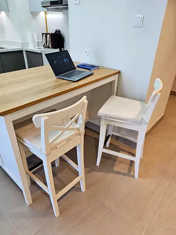 IKEA-style wooden kitchen island with two separately purchased white bar stools
