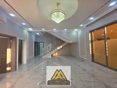 Annual villa for rent in Al Yasmeen, Ajman. Two floors plus rooftop, 5 master bedrooms, premium finishes, prime location close to all services. Annual