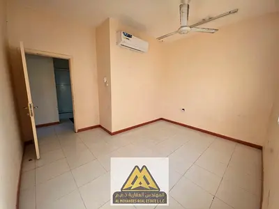 Annual rent: 2-bedroom apartment with a living room, 2 bathrooms, closed kitchen, split A/C, in Al Rawda 3. Annual rent AED 30,000, payable in 4 insta