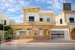 Villa for sale in Ajman, Al Yasmin area, including electricity, water, and air conditioning. It cons