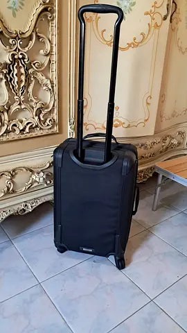 Tumi Compact black carry-on trolley suitcase with extendable handle