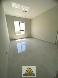 A one-bedroom apartment for annual rent in Al Rawda 3, Ajman, featuring a very spacious layout, a pr