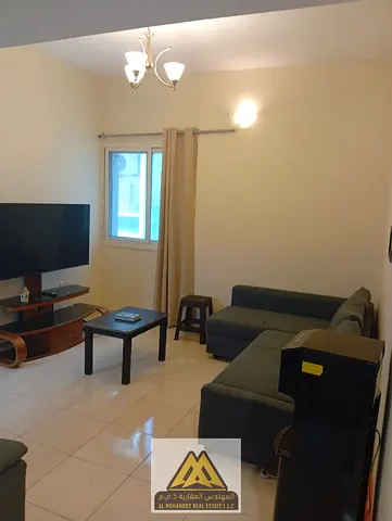 For rent: furnished apartment in Orient Towers, Ajman. AED 32,000 yearly, 1-bedroom + hall, 1 bathroom, gym, pool, parking, prime location, 4 payments