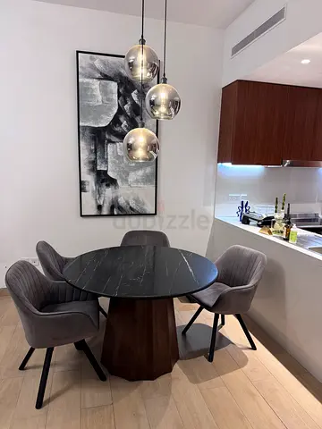 Modern round marble-top dining table with 4 upholstered chairs