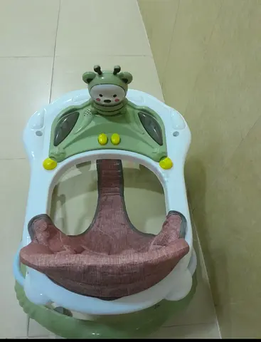 Baby walker with padded seat and toy bar - good condition