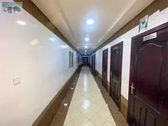 For annual rent: a two-bedroom apartment with a living room in Rashidiya 3, near Grand Mall and Kara