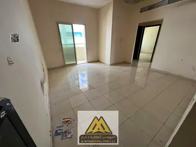 For rent: 2-bedroom apartment with hall in Al Rashidiya 2, Ajman. Balcony, 2 bathrooms, central AC, prime location, close to services. AED 32,000 year