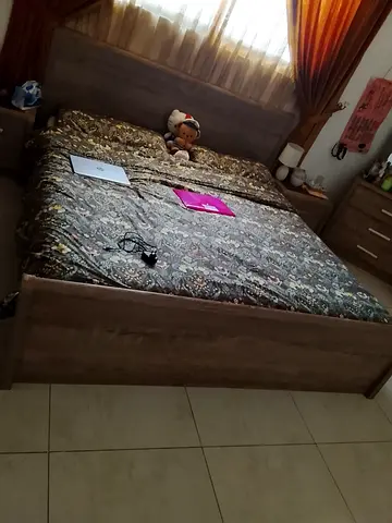 Queen-size wooden bed frame with headboard - good condition with side table drawers