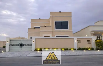A luxurious villa for sale in Al Naseem area, Al Manama, featuring a modern design and spacious layout,