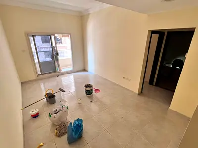 A two-bedroom apartment with a living room for annual rent in Emirates City, Ajman, suitable for fa