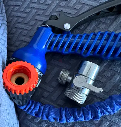 Expandable garden hose with spray nozzle and shut-off valve - used