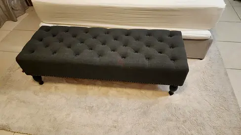 Dark grey tufted ottoman bench with nailhead trim
