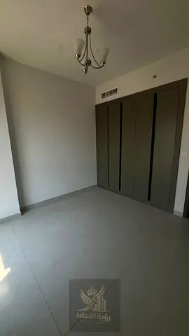Two bedrooms and a living room, first occupancy in Abu Shagara, with two bathrooms, a balcony, high-end finishing, and a prime location close to all s