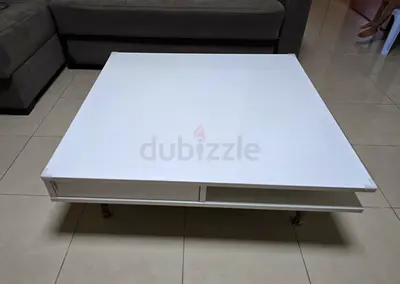 Low white modern coffee table from ikea with storage shelf and drawers